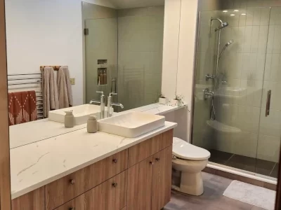 bathroom-update-aspect-ratio-400-300 Updated bathroom with wood vanity, vessel sink, glass shower enclosure, and tile flooring