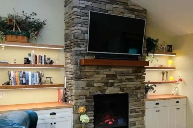 custom-floating-shelves-1-aspect-ratio-960-640 Floating shelves with built-in cabinets surrounding a stone fireplace and mounted television