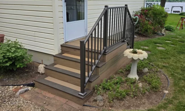 Decatur Entry-A After view of replaced entry stairs with new dark railing, and improved access to the lakeside yard