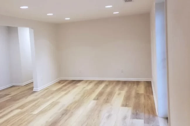 finish-basement-update-1-aspect-ratio-960-640 Finished basement living area with light wood-look flooring, recessed lighting, painted walls, and white trim