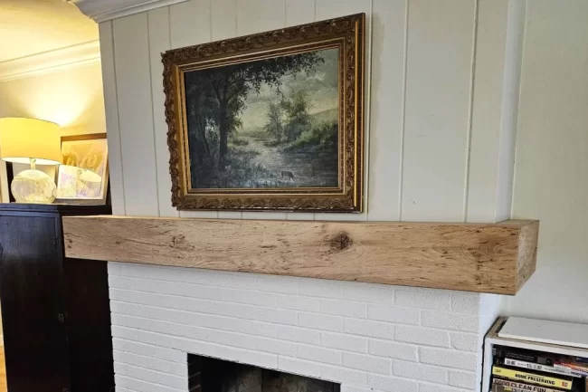 fireplace-mantel-aspect-ratio-960-640 Natural wood fireplace mantel installed above a white brick fireplace with vertical wall paneling