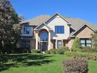 home-exterior-updates-aspect-ratio-400-300 Two-story home exterior with updated siding, windows, brick details and landscaped front yard