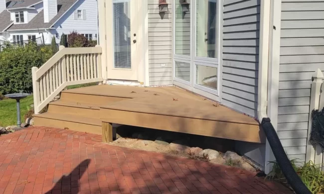 kalamazoo-deck-replace-after-aspect-ratio-1000-600 After view of repaired backyard deck with new deck boards, updated railing, and clean transition to the brick patio