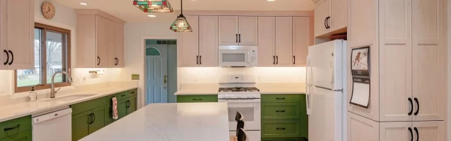 kitchen-cabinet-countertop-update-scaled-aspect-ratio-1920-600 Updated kitchen with green lower cabinets, light upper cabinets, white countertops, island, and pendant lighting