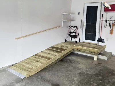 miscellaneous-accessibility-updates-aspect-ratio-400-300 Wood access ramp and platform for accessibility built inside a garage near an entry door with storage hooks and shelves