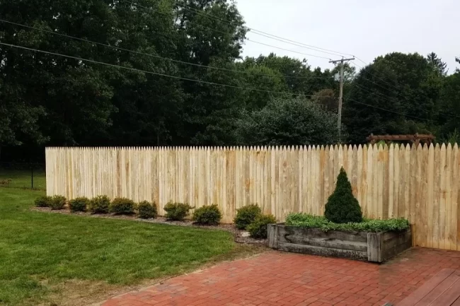 wood-fence-repair-aspect-ratio-960-640 New wood privacy fence installed along a backyard patio with landscaping and a raised planter